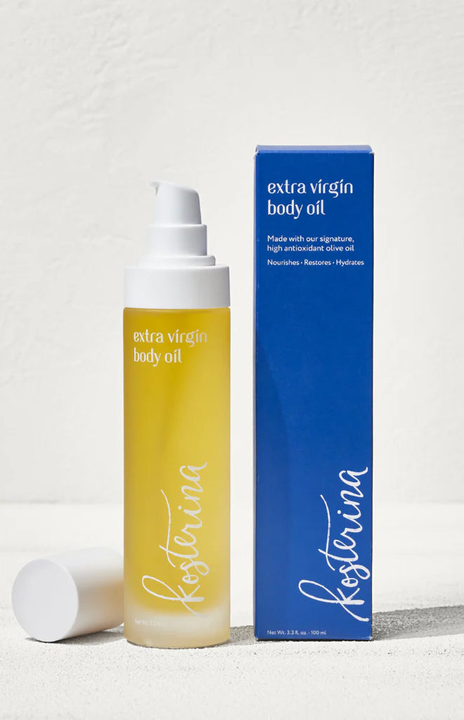 Front view of Kosterina Extra Virgin Body Oil bottle and box showing pump dispenser and yellow oil on white textured background