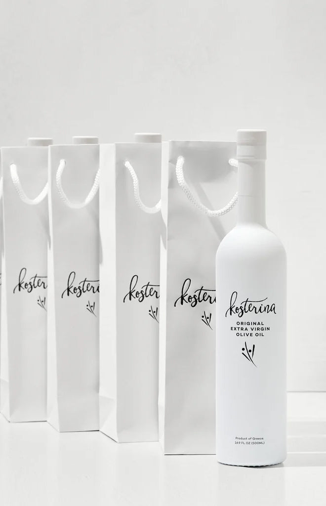 Front view of Kosterina Original extra virgin olive oil 500 ml bottle with matching white gift bags lined up on a white background