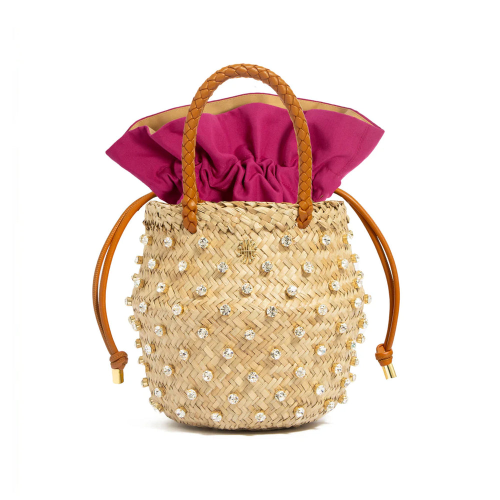 Front view of Nina Crystal Cotton in Bougainvillea showcasing crystal-embellished straw body, magenta drawstring lining, and braided leather handles on white background