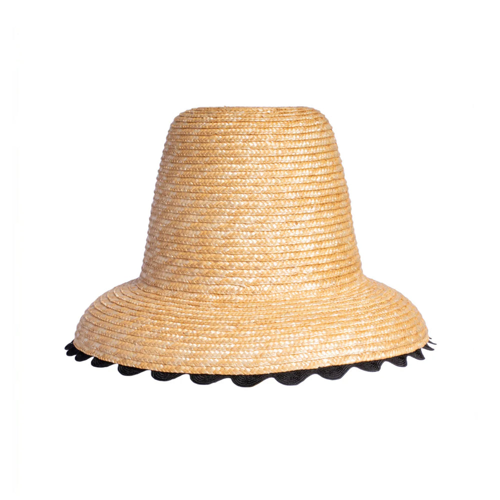 Front view of Le Nine Wavy Hat in natural raffia showcasing scalloped black wavy trim on the brim against a white background