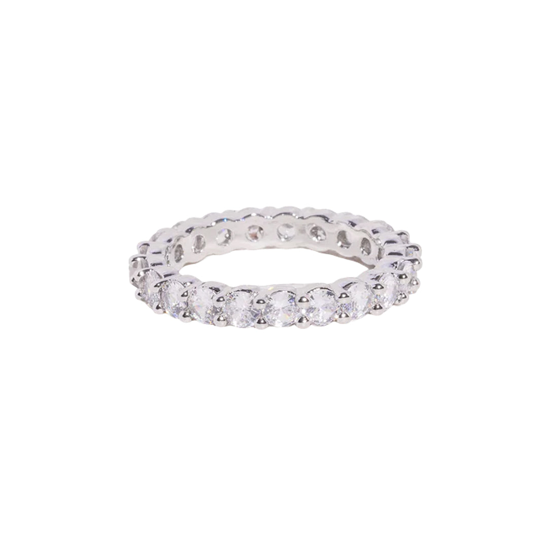 Angled view of Theo Ring in silver showcasing continuous CZ stones around a slim eternity band on white background