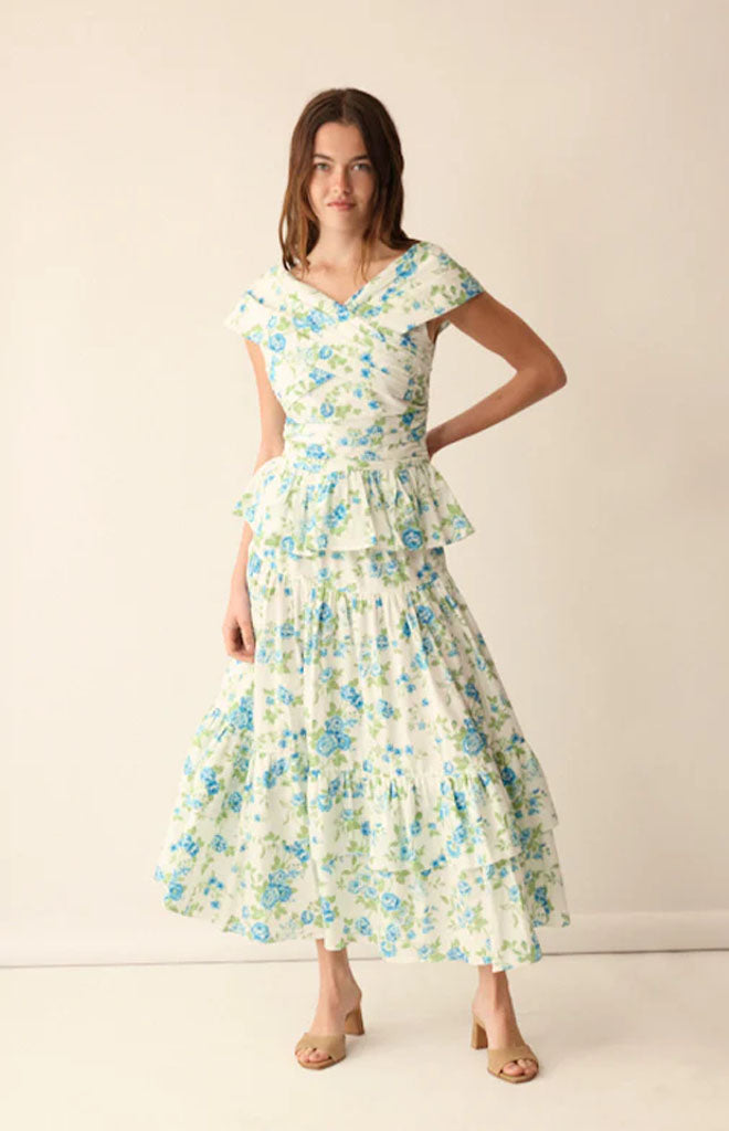 Front view of Lily Top in Green showcasing its peplum silhouette and pleated bodice on a model against a neutral background