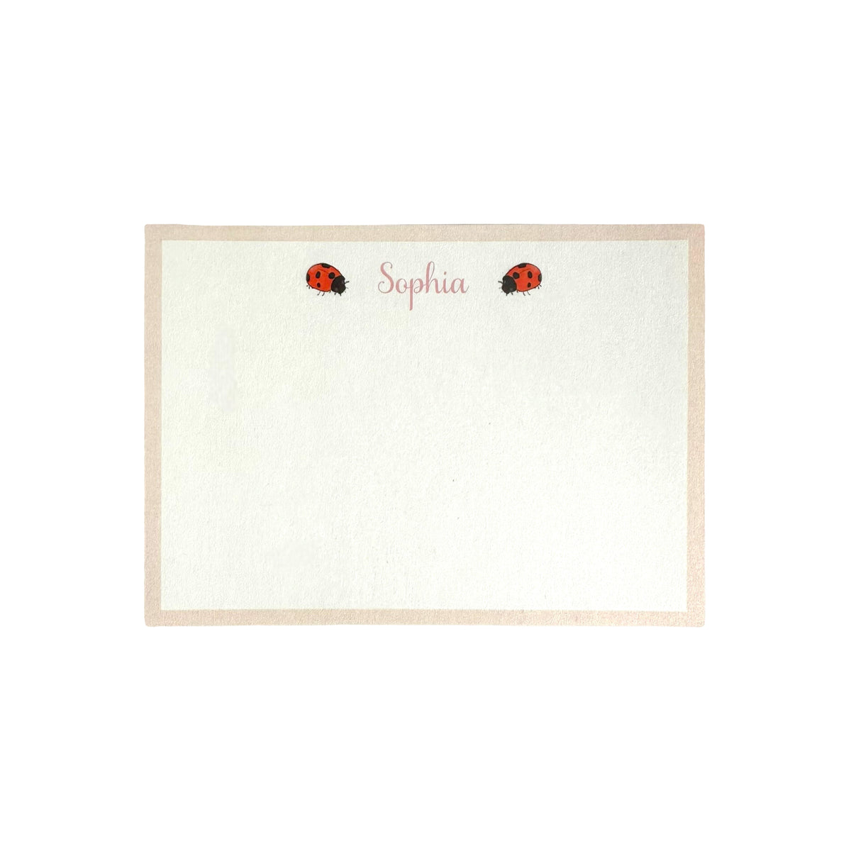 Flat lay of Ladybird Notecard showing personalized name Sophia in pink script and two ladybug illustrations with a beige border on a white background