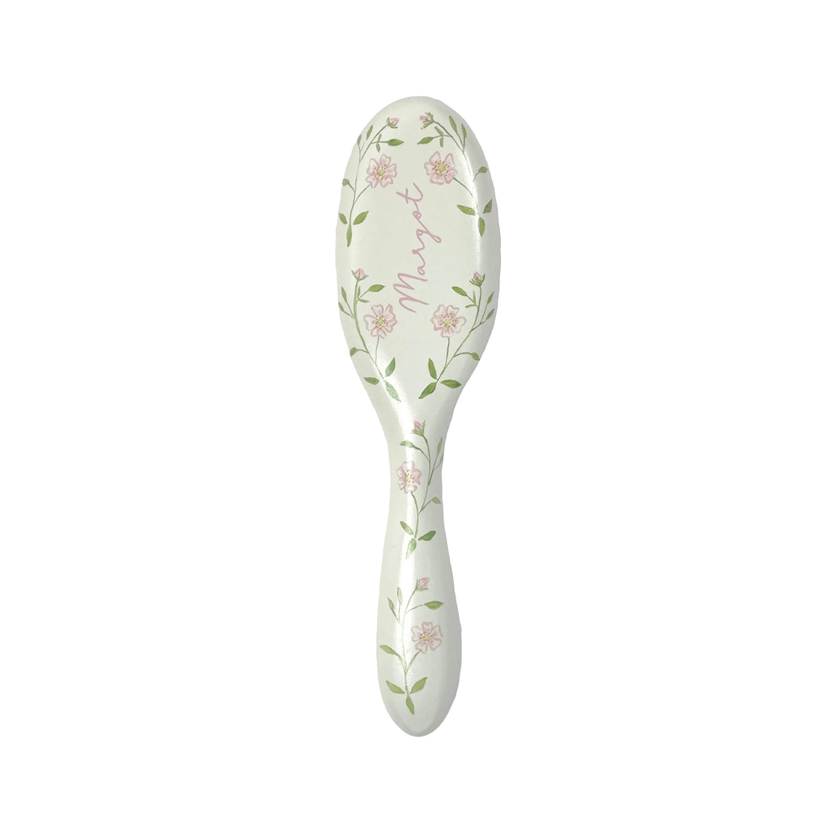 Top view of baby brush in Roses showcasing hand-painted pink floral pattern and visible cursive name Margot on white background