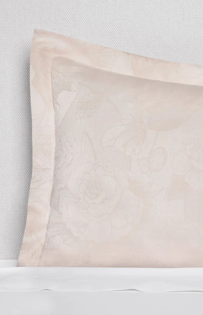 Front close up of Adrina sham in Cameo showing floral jacquard and narrow flange border on light textured background