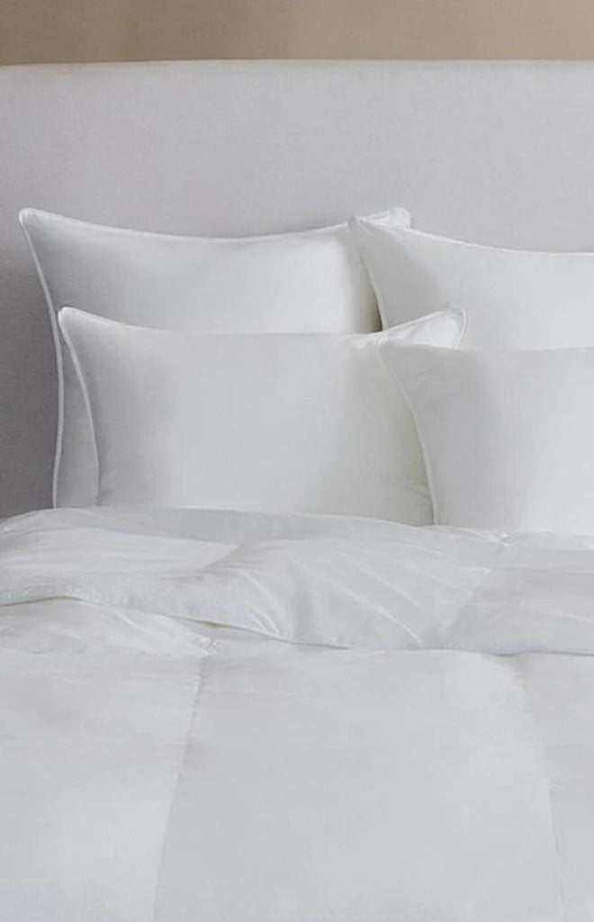 Front view of Arcadia duvet showing white cotton sateen finish and baffle box stitching on a bed with a neutral headboard