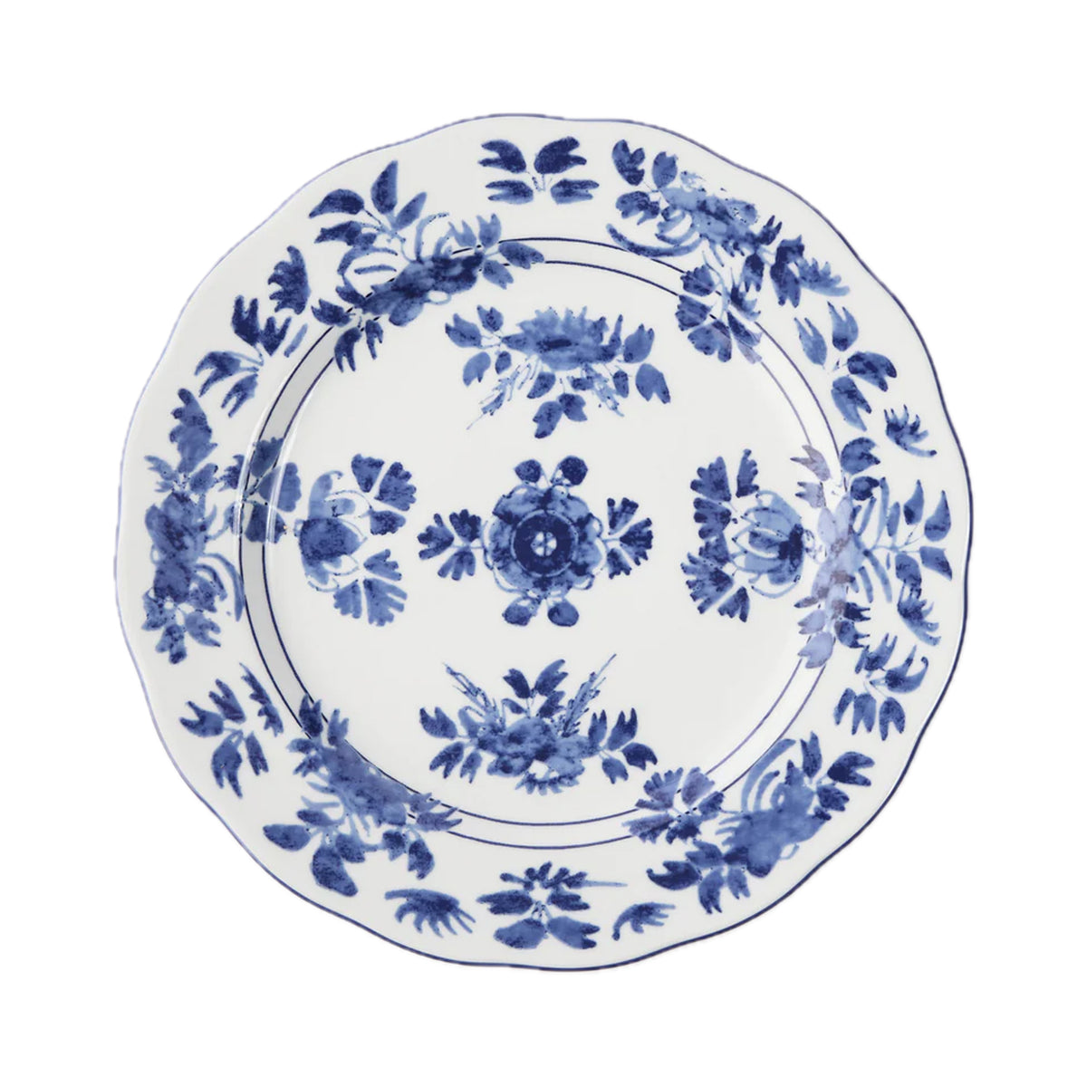 Top-down view of Gloria porcelain dinner plate showcasing blue watercolor floral pattern and scalloped edge on white background