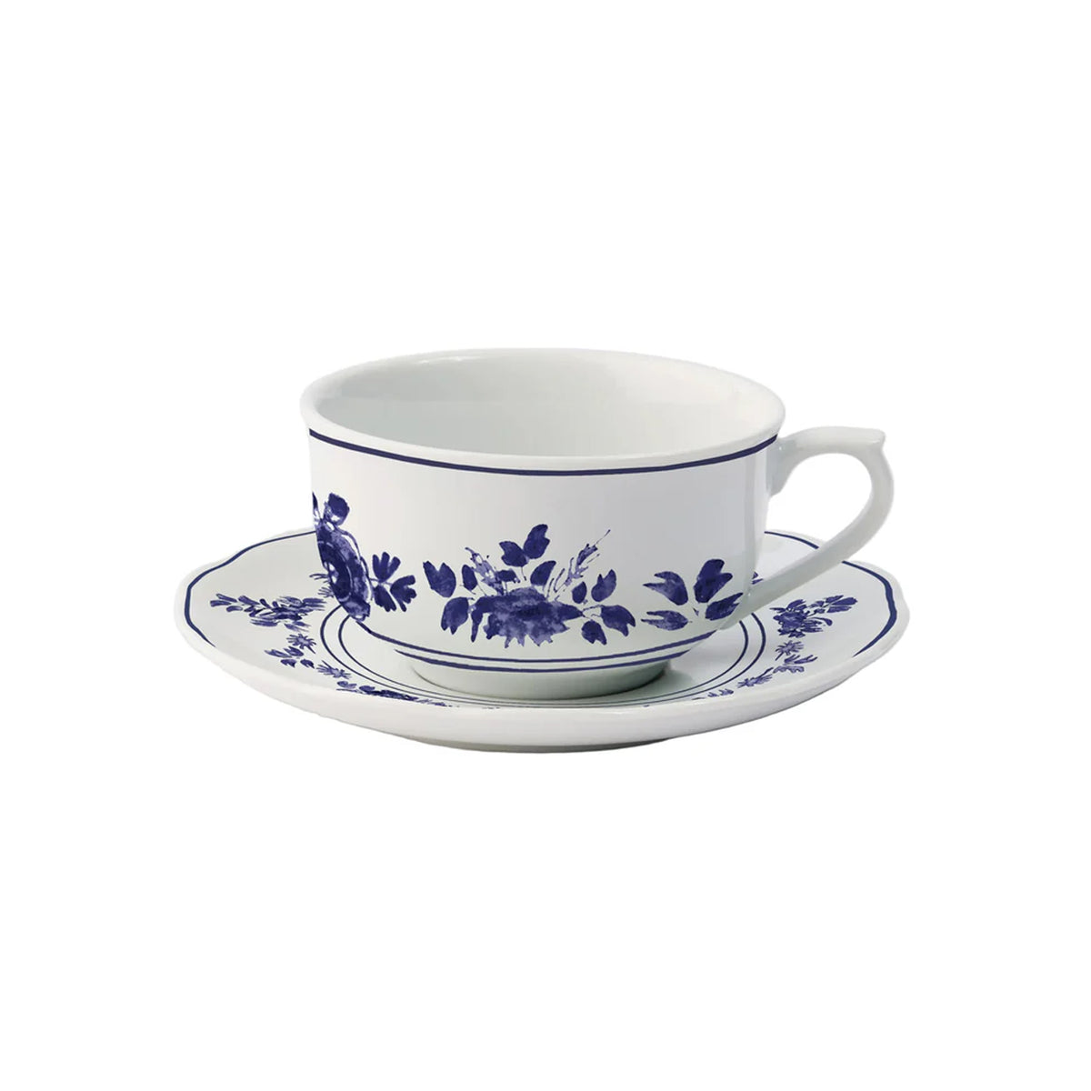 Three-quarter view of Gloria porcelain teacup and saucer showcasing blue floral pattern on white background
