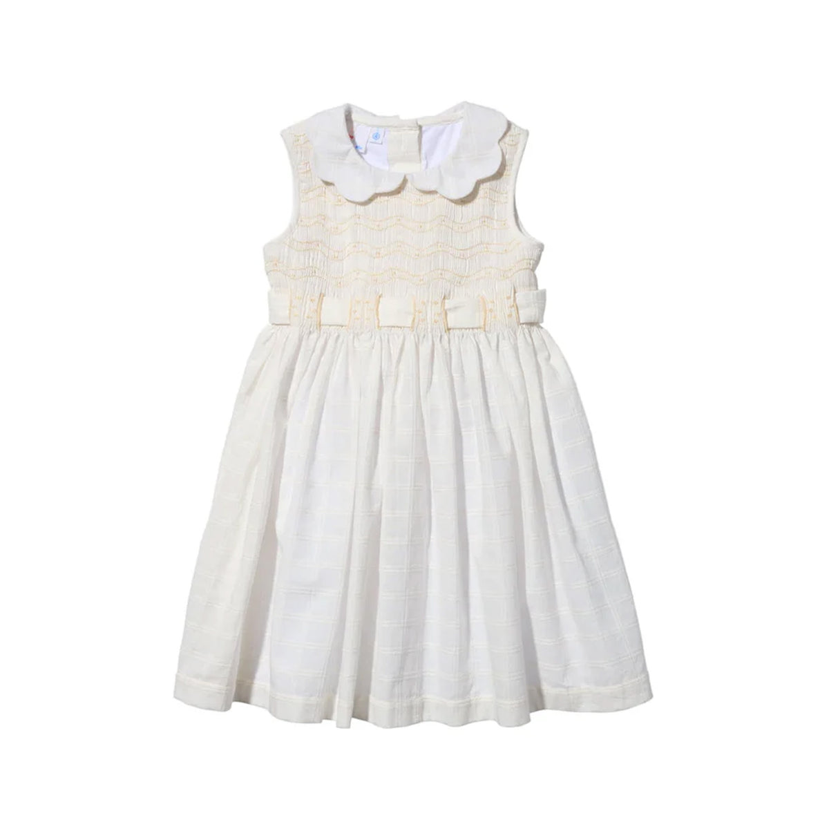Front view of Olive Dress in Cream Windowpane showcasing scalloped collar, hand smocking, and waist bows on white background