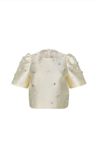 The Olivia Top is our duchess satin short-sleeve with hand-embroidered pearl-and-rhinestone detail