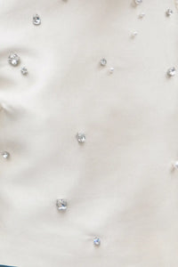 The Olivia Top is our duchess satin short-sleeve with hand-embroidered pearl-and-rhinestone detail