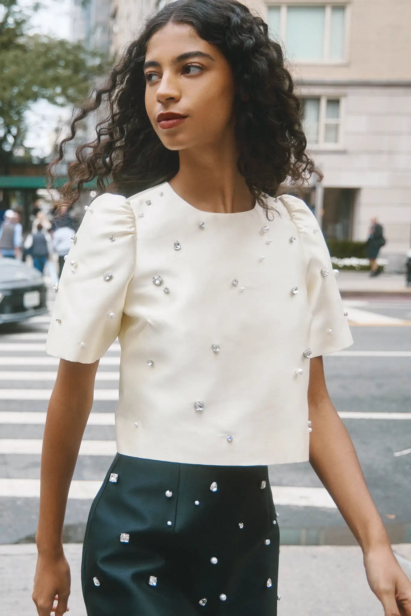 The Olivia Top is our duchess satin short-sleeve with hand-embroidered pearl-and-rhinestone detail