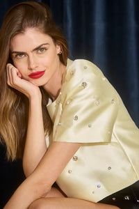 The Olivia Top is our duchess satin short-sleeve with hand-embroidered pearl-and-rhinestone detail