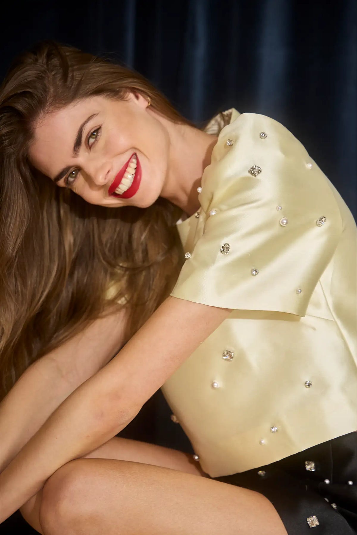 The Olivia Top is our duchess satin short-sleeve with hand-embroidered pearl-and-rhinestone detail