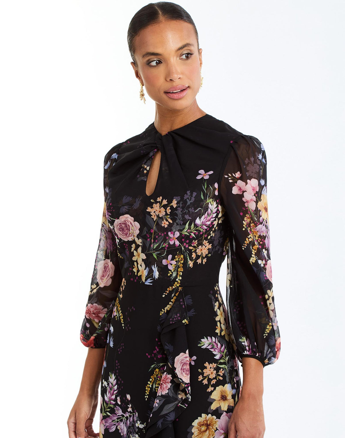 Ophelia Chiffon Gown in Twilight Florals side – chiffon evening gown with twisted keyhole neckline, sheer balloon sleeves, and cascading ruffle skirt by Mestiza New York.