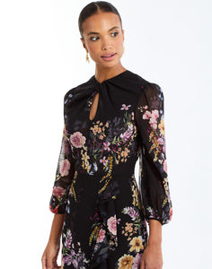 Ophelia Chiffon Gown in Twilight Florals side – chiffon evening gown with twisted keyhole neckline, sheer balloon sleeves, and cascading ruffle skirt by Mestiza New York.