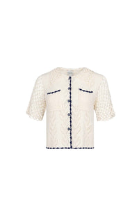 The Ophelia Sweater has short sleeves, novelty painted flower buttons, and scalloped edging.