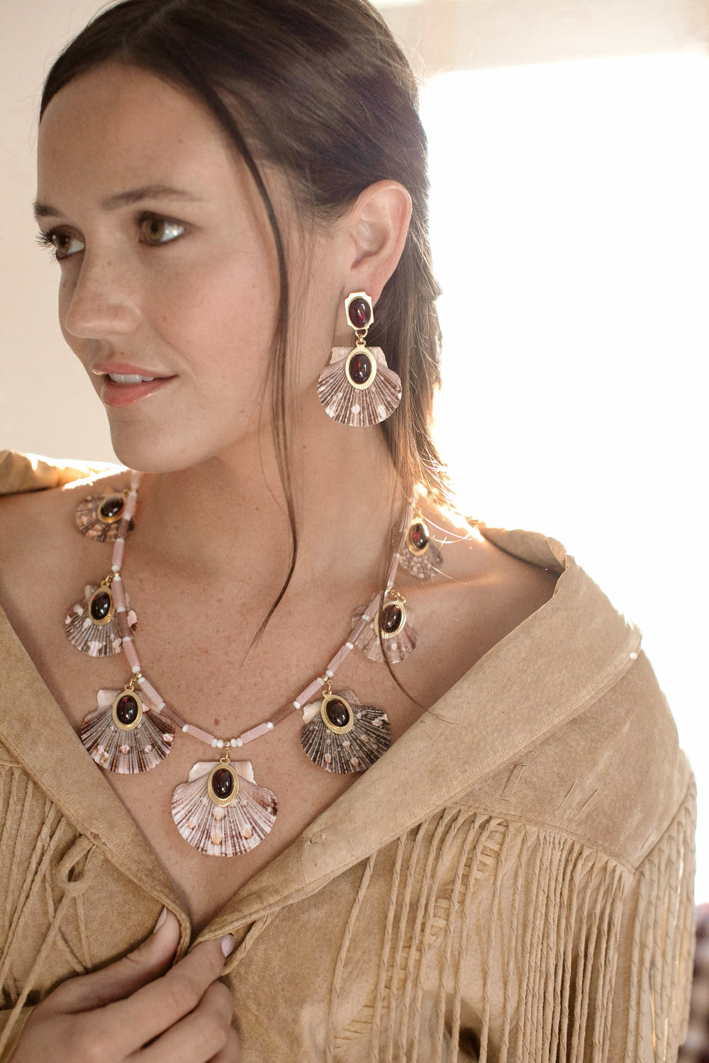 Close-up of Ophelia Necklace on model showing scallop shell pendants with garnet cabochons and pink opal and strawberry quartz beads