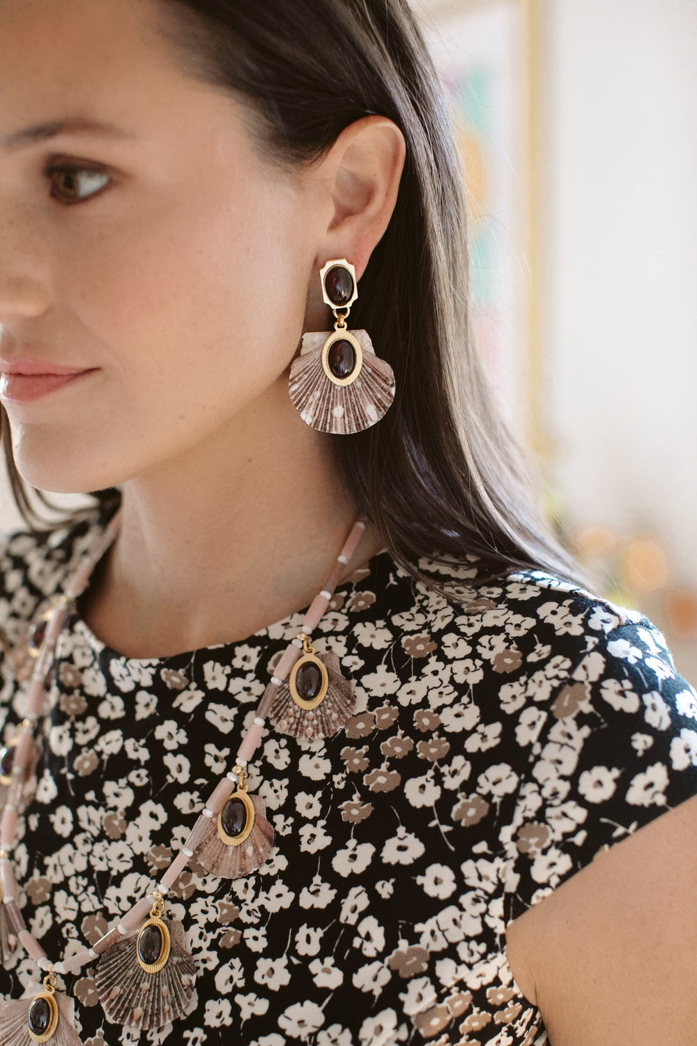 Close-up of Ophelia Earrings on model’s left profile showcasing scallop shell drops and garnet-set gold-plated toppers