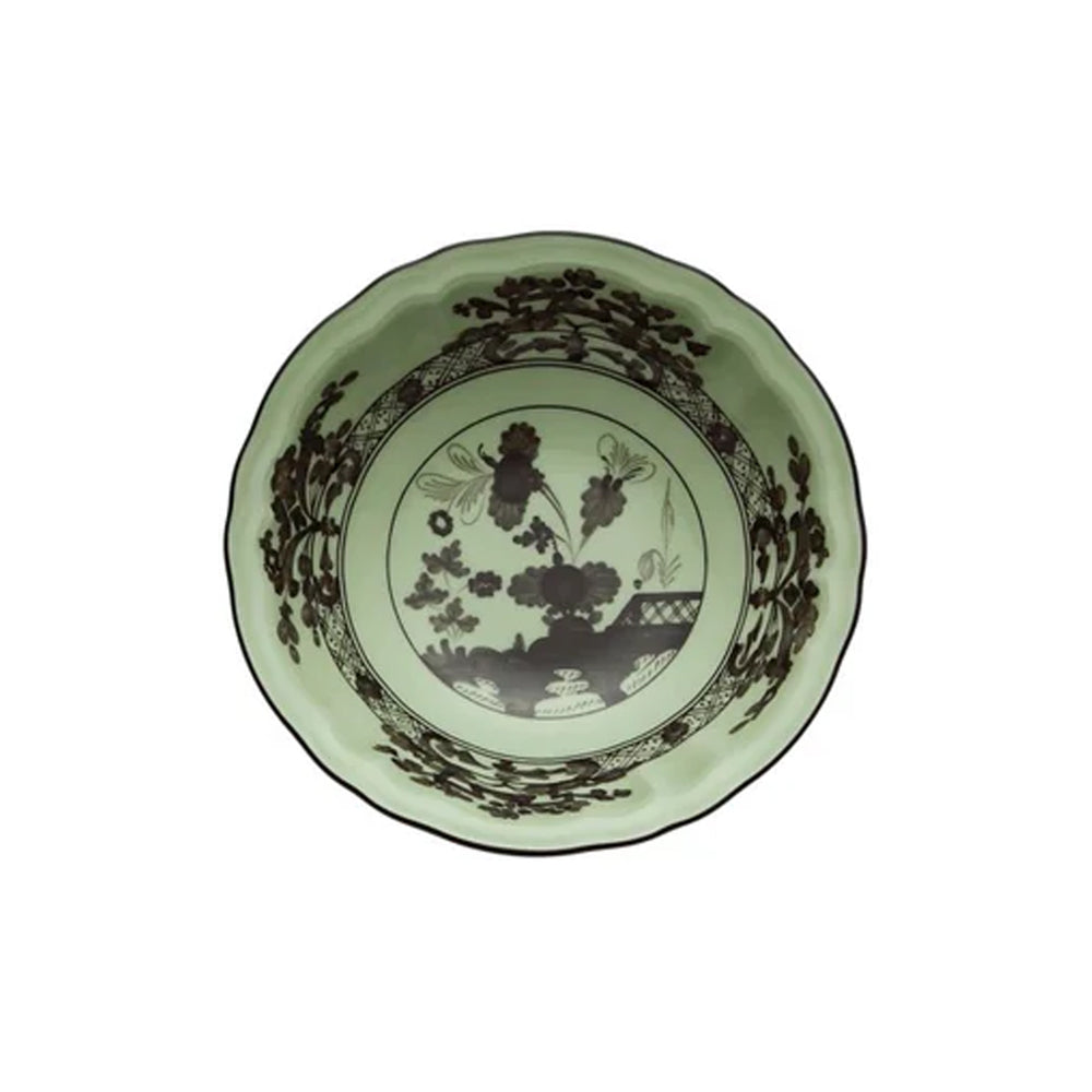 Top view of Oriente Italiano fruit bowl showing pale green glaze, brown floral pattern and scalloped rim on white background