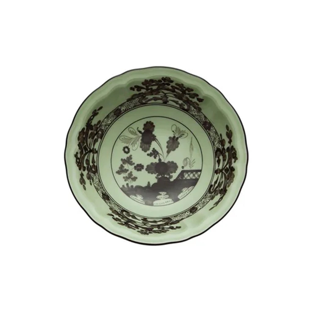 Top view of Oriente Italiano fruit bowl showing pale green glaze, brown floral pattern and scalloped rim on white background