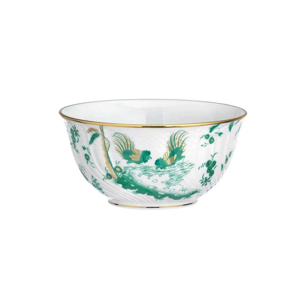 Three-quarter view of Oro Di Doccia porcelain bowl showcasing green rooster and floral motif with gold rim on white background