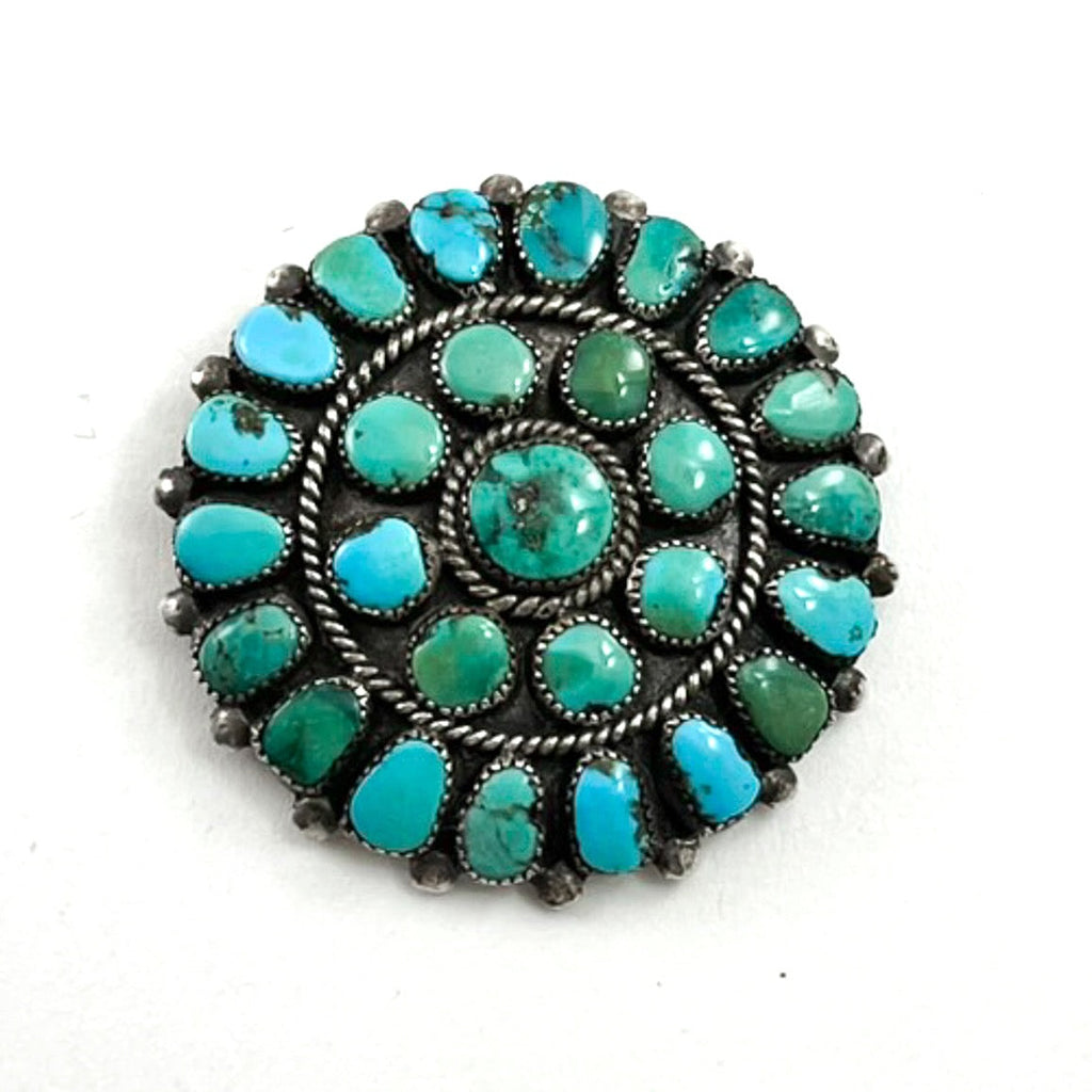 Front view of vintage cluster pin showcasing natural American turquoise stones in sterling silver with white background