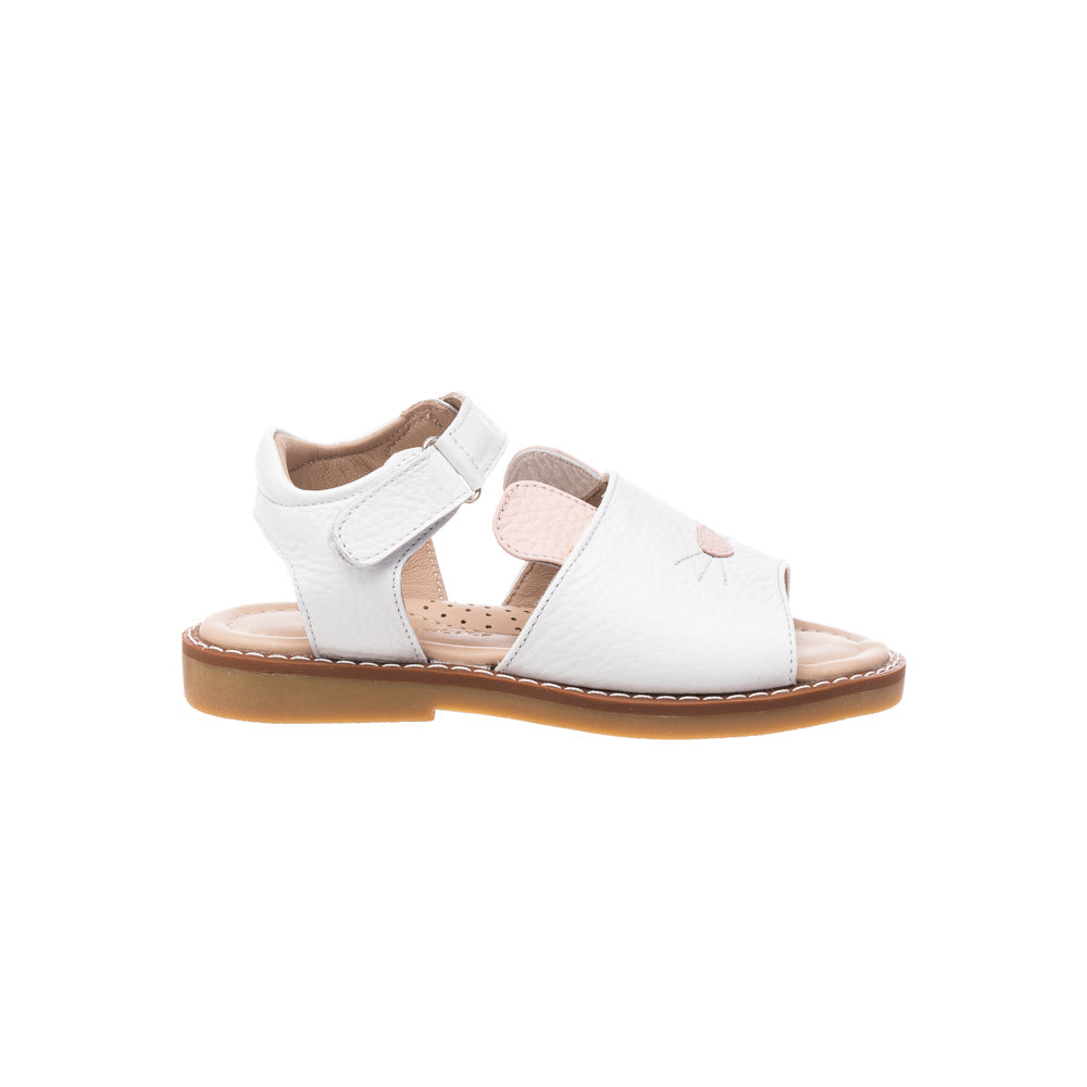 Side view of white Bunny sandal showing open toe, pink bunny nose and whisker detail, adjustable Velcro ankle strap on white background