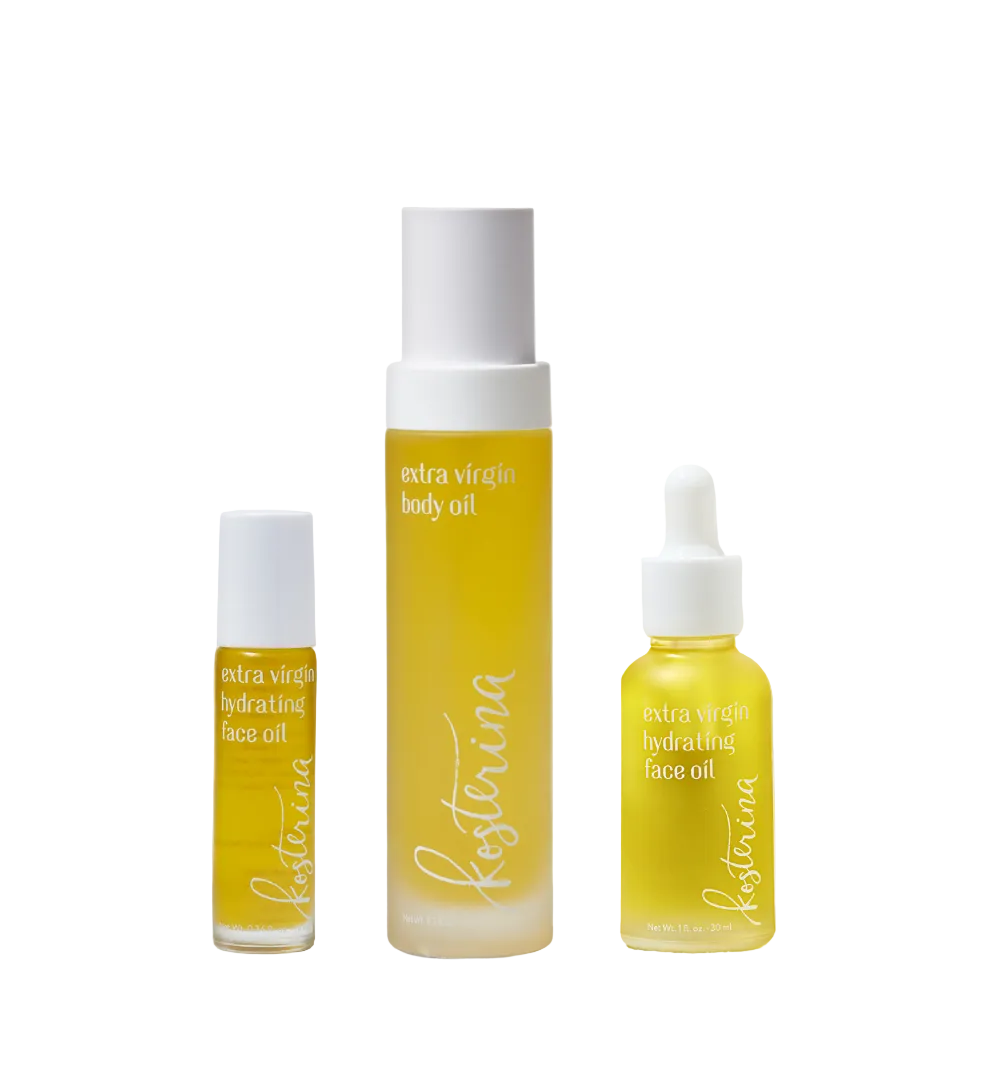 Front view of Let It Glow skincare set with three oil bottles: body oil, dropper face oil, and face oil rollerball on white
