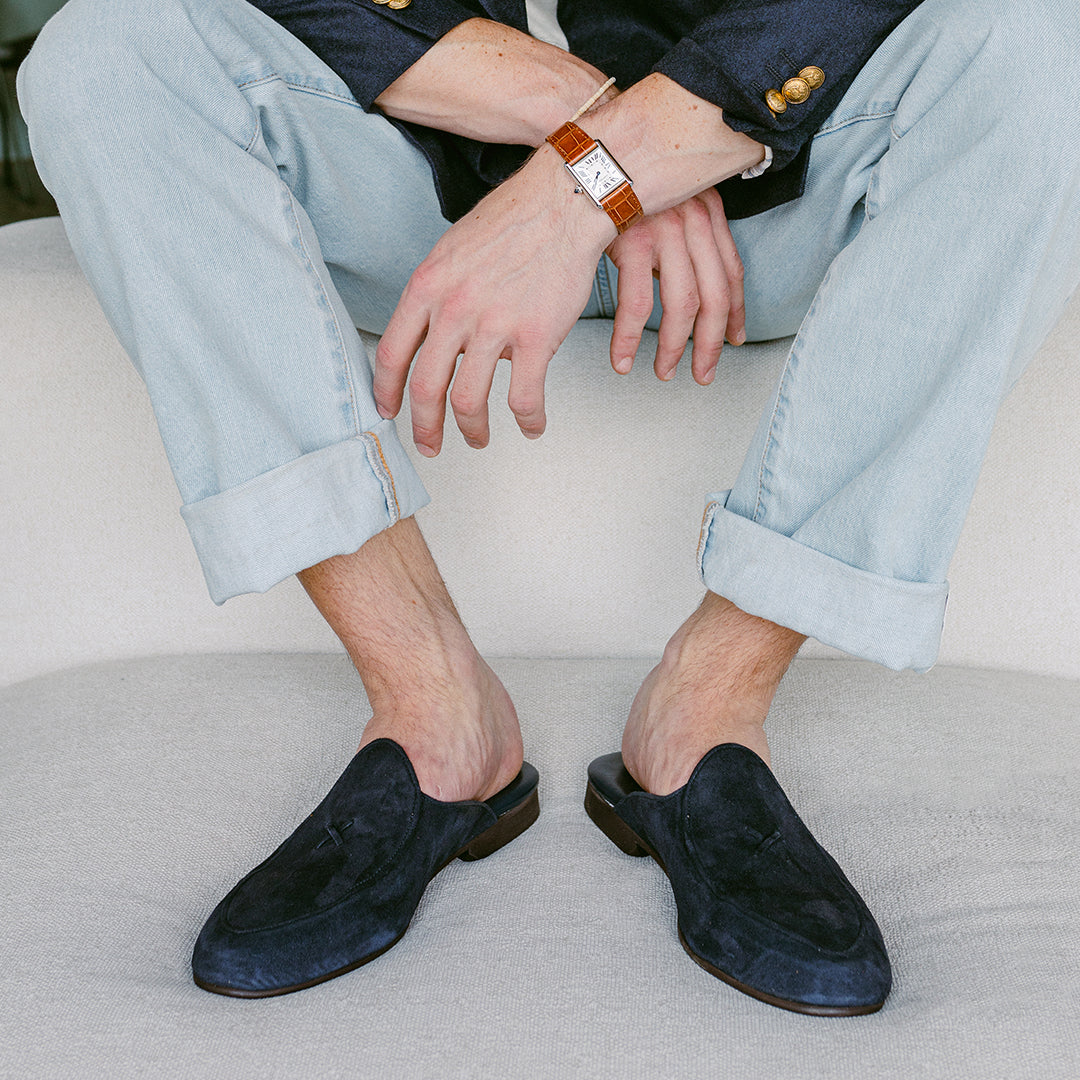 Front view of Navy Suede Milano Mule showcasing suede uppers and open heels on a seated model