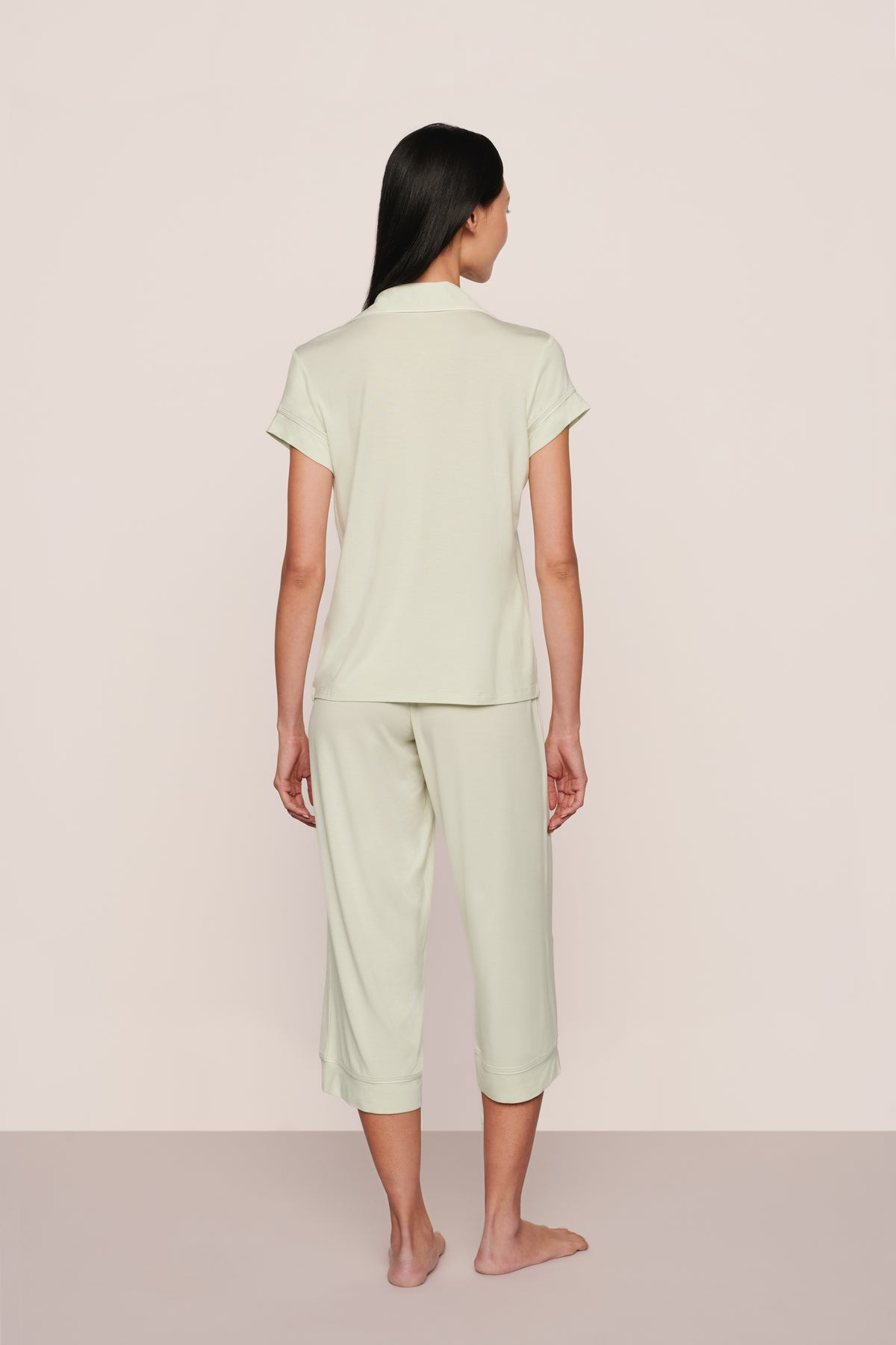 Rear view of Gisele short-sleeve crop pajama set in seafoam/ivory showing cropped top and capri pants on model