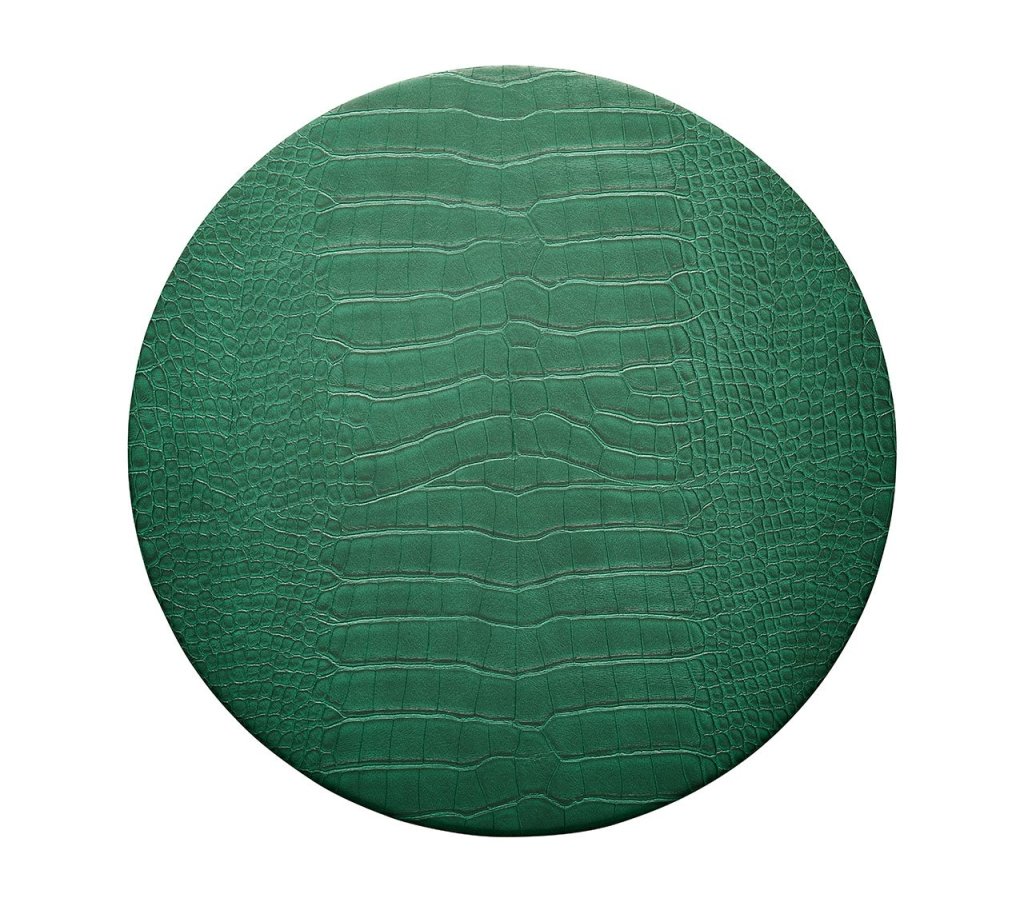 Top-down view of round Croco placemat in emerald showcasing crocodile-embossed texture on white background