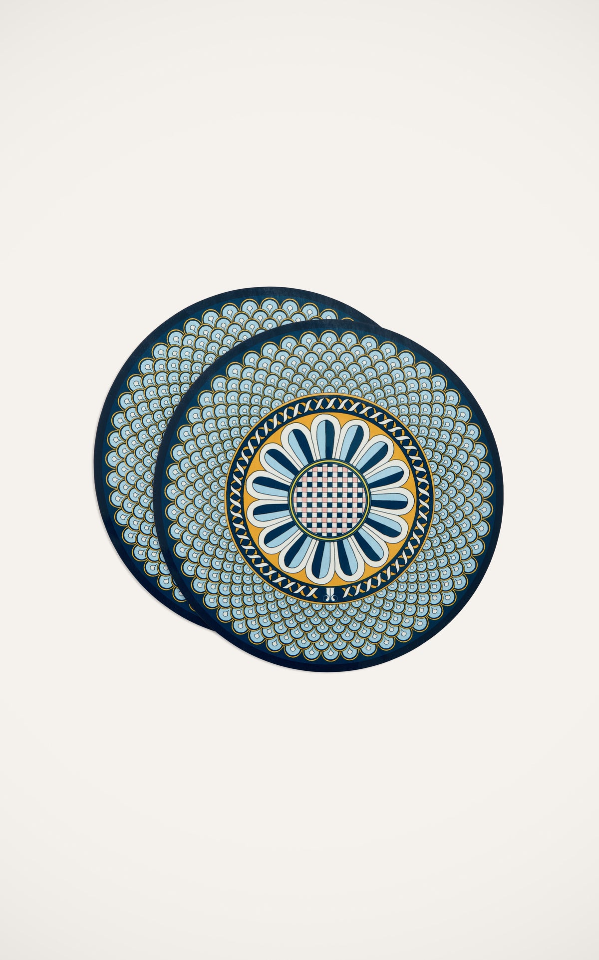 Top view of Disk Placemats in Napoli Midnight, set of 2 showcasing ornate blue, yellow, and white motif on cream background