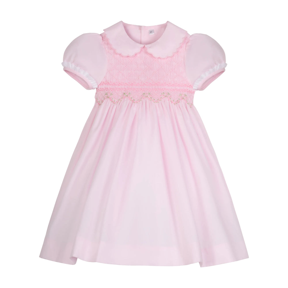 Front view of Sofia Dress showing smocked embroidered yoke, puff sleeves, scalloped Peter Pan collar on white background