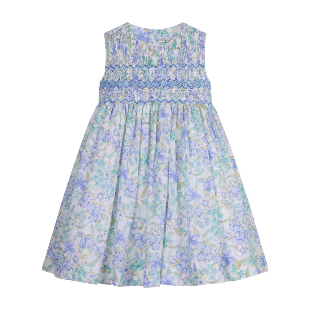 Front view of Carlota Dress showcasing hand-smocked bodice, sleeveless cut, and pastel blue-green floral print on white background