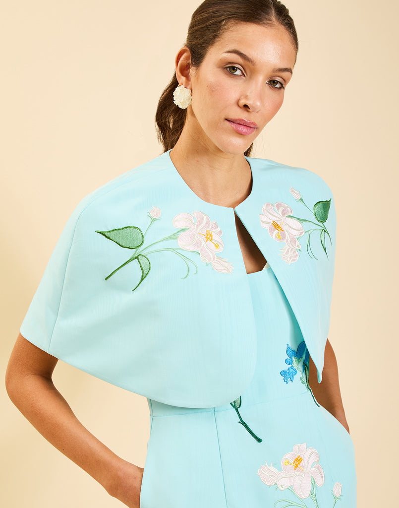 Pacifica Midi Dress in Blue Waltz moire with hand-sewn floral embroidery, peek-a-boo neckline, boned bodice, and side pockets.