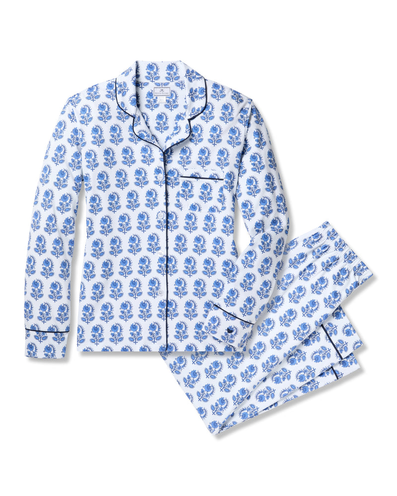 Experience luxury with the Womens Pima Pajama Set in Bristol Bay by Petite Plume. Made from soft Peruvian Pima cotton, it features a white long-sleeve button-up shirt with a chest pocket, blue floral patterns, and matching pants. Black piping adds sophistication to this elegant ensemble.
