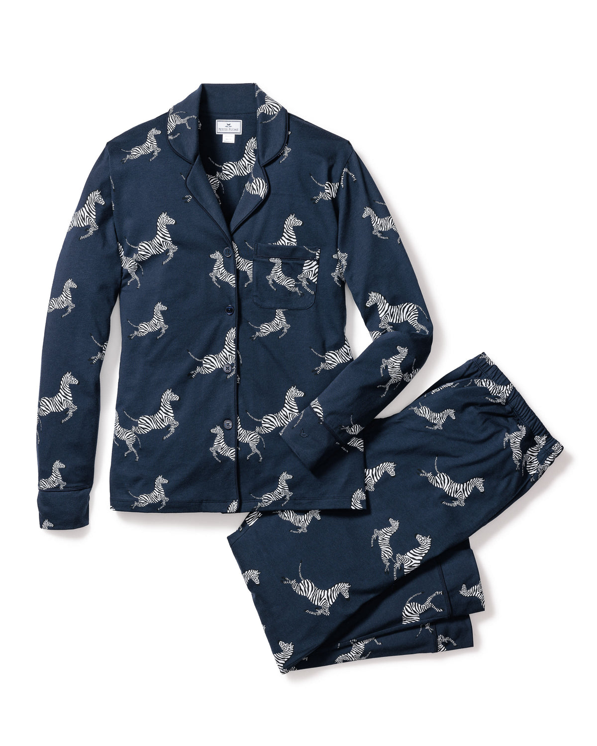 Top view of Women’s Pima Pajama Set in Zèbre de Nuit with zebra print, navy piping, pearl buttons on white background
