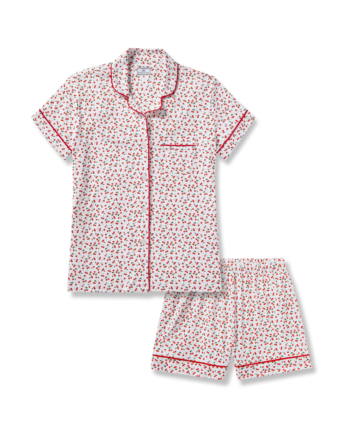 The Petite Plume Womens Pima Short Sleeve Short Set in Cherry Orchard features a white jersey knit with a cherry print, red piped collar, chest pocket, and matching shorts with an elastic waistband.