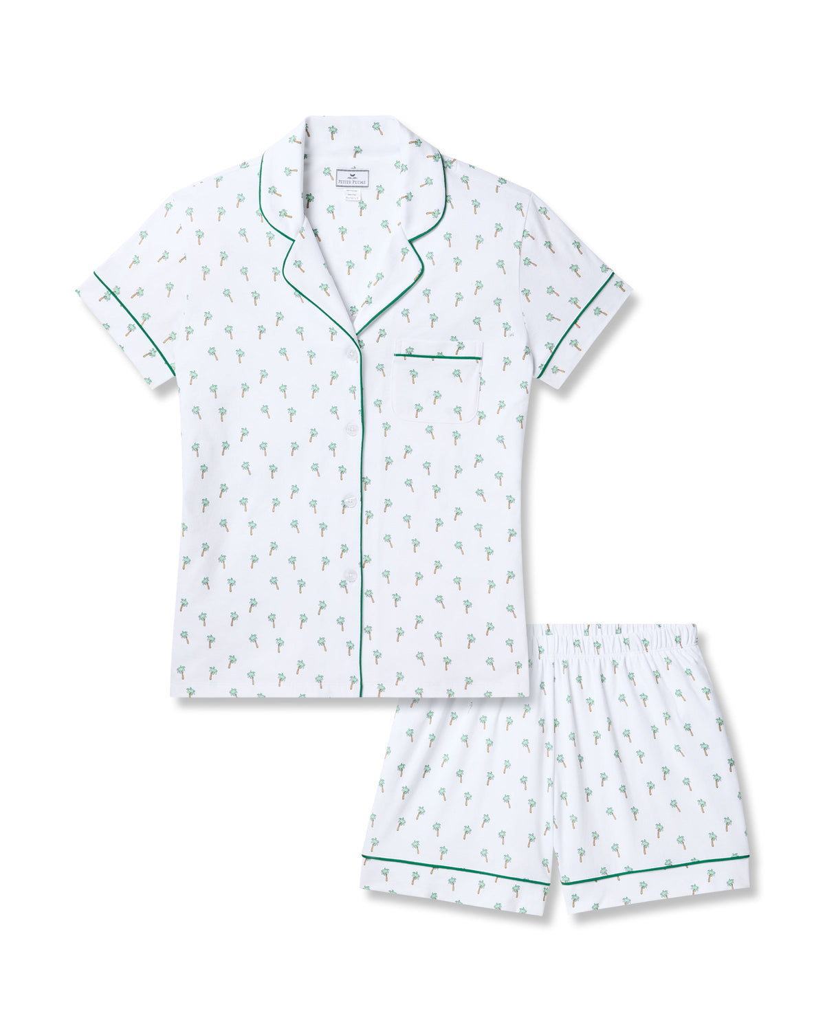 Petite Plumes Womens Pima Short Sleeve Short Set in Palmier features a white, palm tree-printed pajama set made from luxurious Peruvian Pima cotton. The button-up top includes a chest pocket and green piping, while the elastic-waist shorts also feature matching green piping for comfort and style.