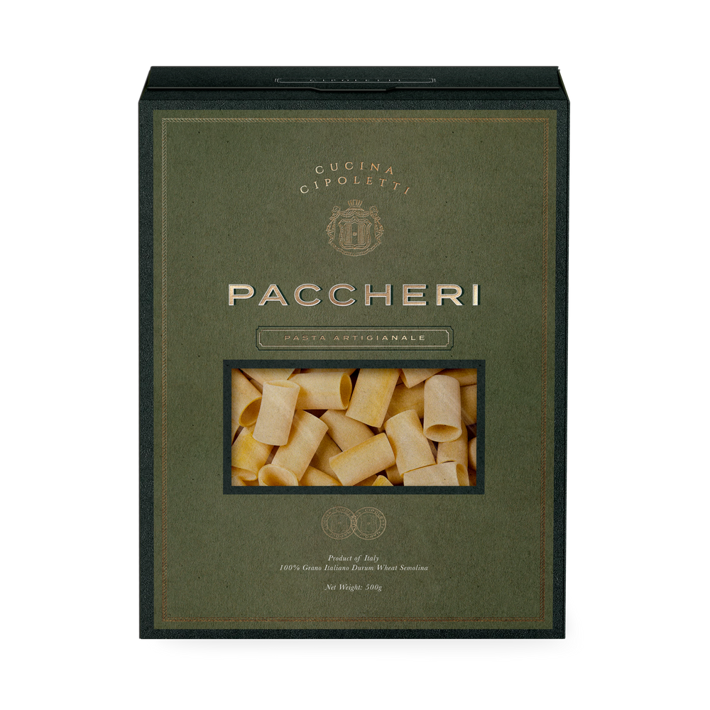 Front view of Paccheri pasta box showing rectangular window of tube-shaped pasta, olive-green textured packaging and gold lettering