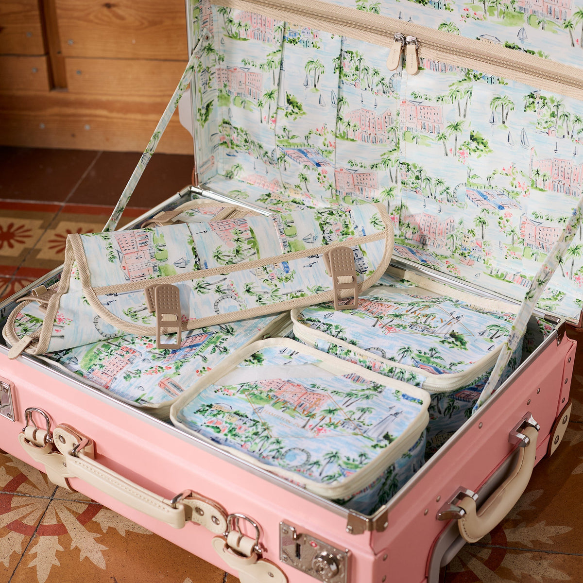 Close view of Hamilton Princess Bermuda x SteamLine packing cube set showcasing watercolor pattern in an open pink suitcase
