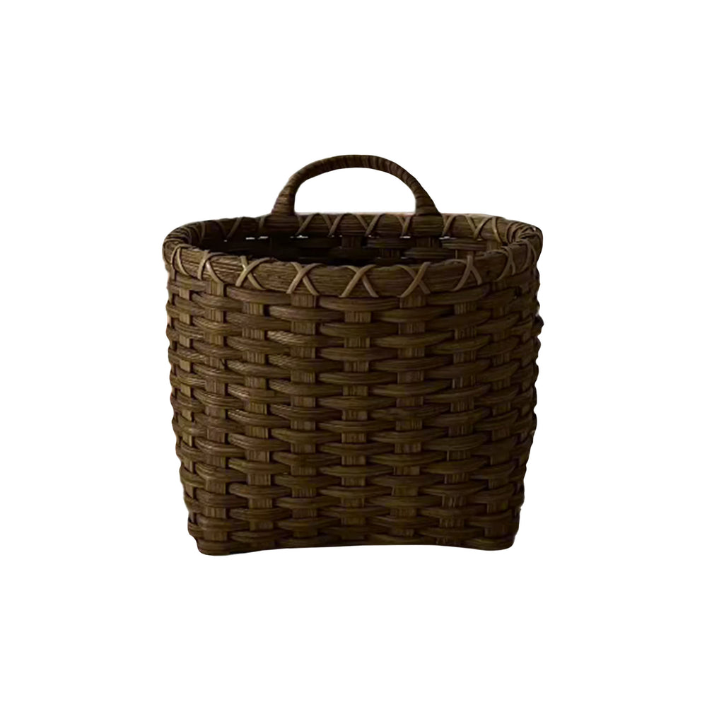 Front view of Panier de Biscuit rattan basket showing woven pattern, loop handle, and rounded square shape on white background