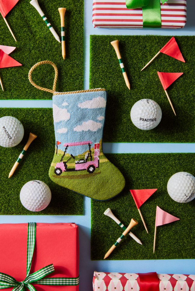 Top-down view of Par-Tee Time stocking showing needlepoint pink golf cart on green fairway with faux turf and golf balls
