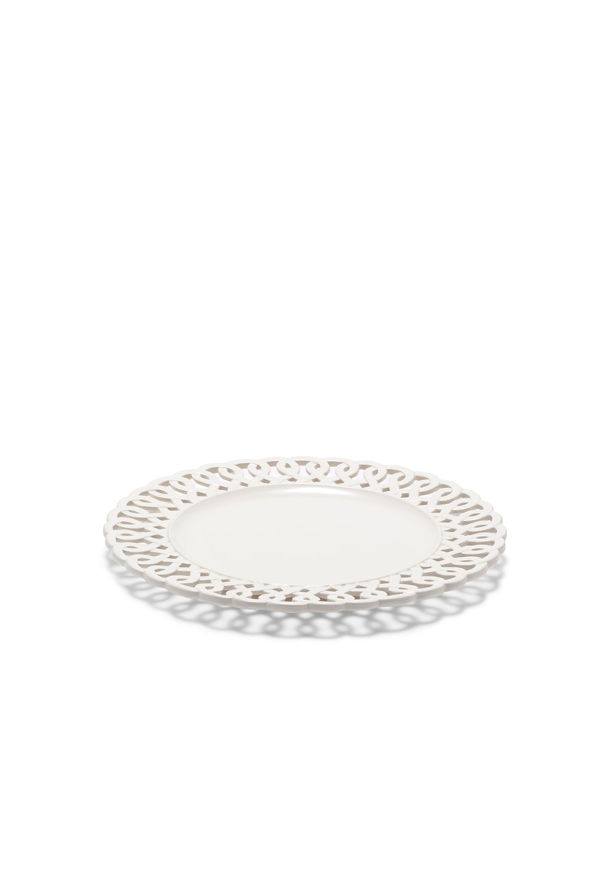 Angled view of the Paulette Dinner Plate White showcasing its intricate cutout rim on a white background