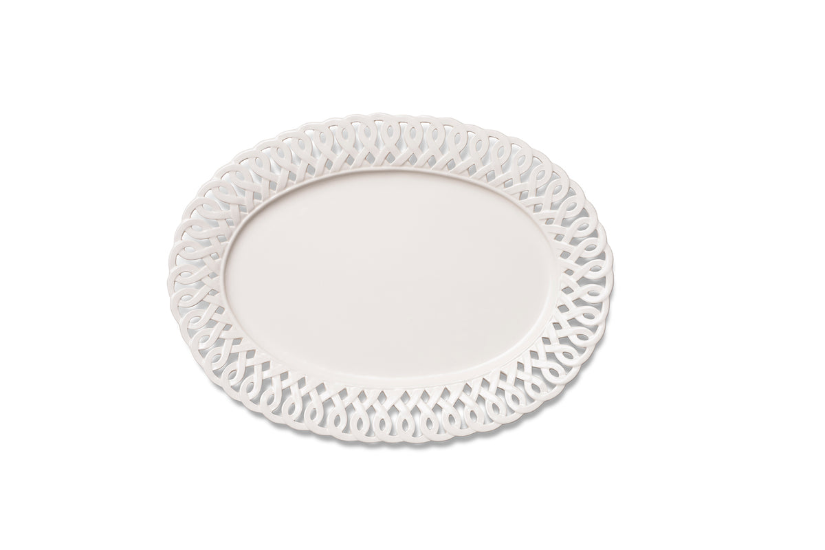 Overhead view of Paulette oval platter in white showcasing intricate cutout lattice rim on white background