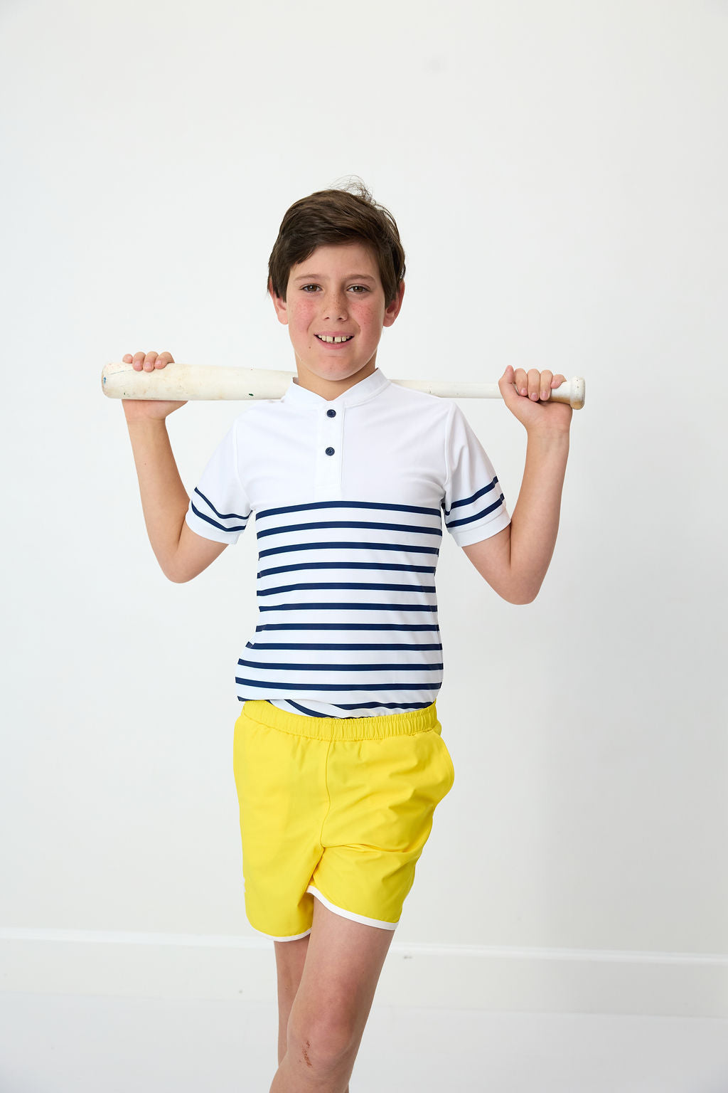 Front view of Breton Stripe Blade Shirt with blade collar and navy stripes on child model with white background