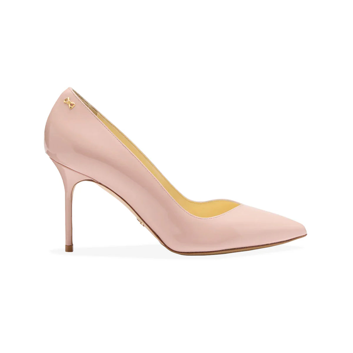 Side view of Perfect Pump 85 in Petal Patent showcasing a light pink pointed toe and slim high heel on a white background