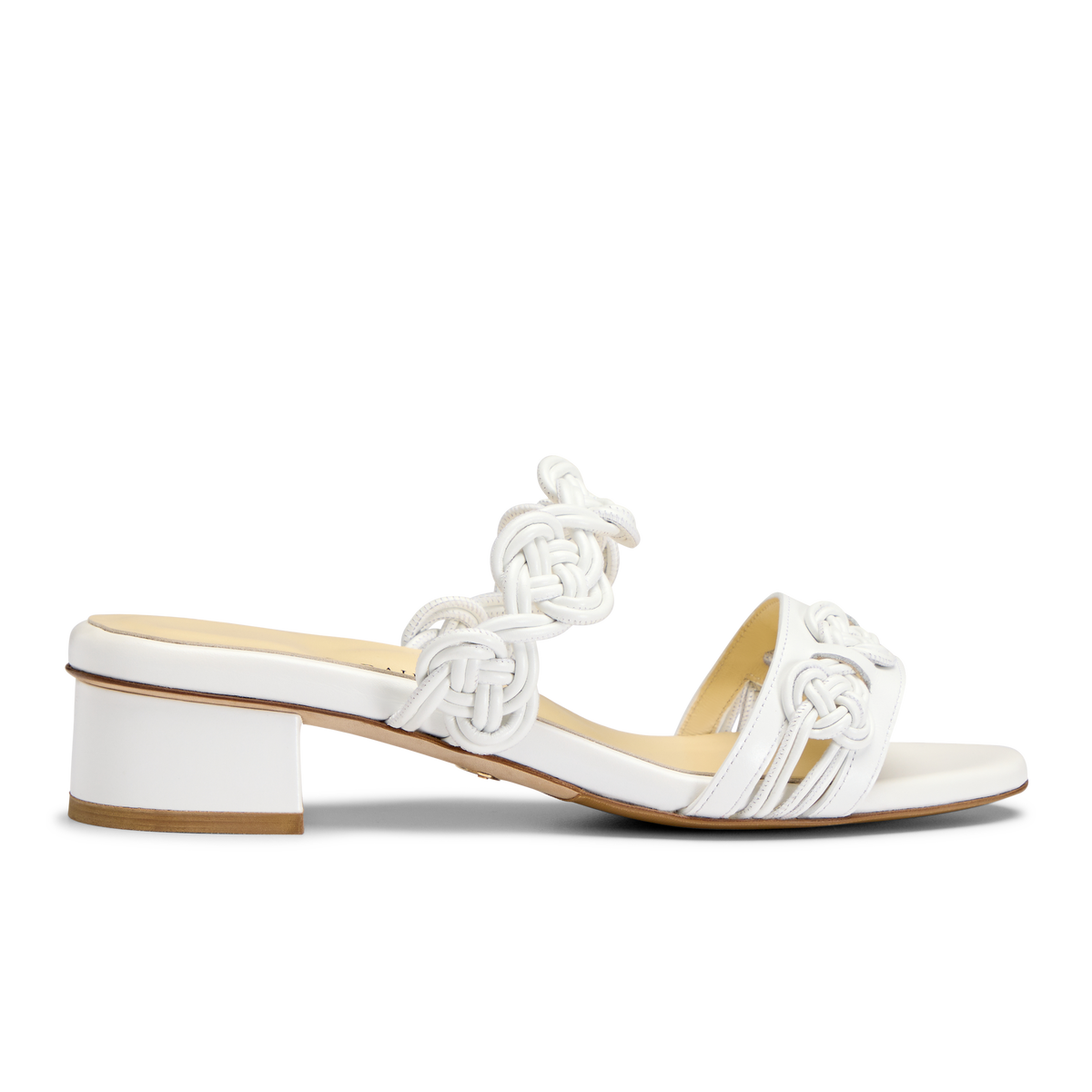 Side view of Perfect Celeste 30 in White Calf mule with handmade knot detailing and low block heel on white background