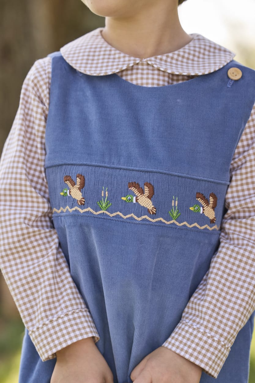 Little English traditional children's clothing.  Khaki Gingham peter pan shirt for toddler boys paired with stormy blue corduroy john john with flying mallard smocking across chest. 